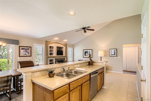 6114 Salvia Ln, Arvada, CO 80403 - kitchen with dishwasher, a sink, open floor plan, brown cabinetry, and a center island with sink