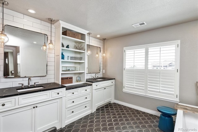 full bath featuring visible vents, baseboards, a textured ceiling, recessed lighting, and vanity