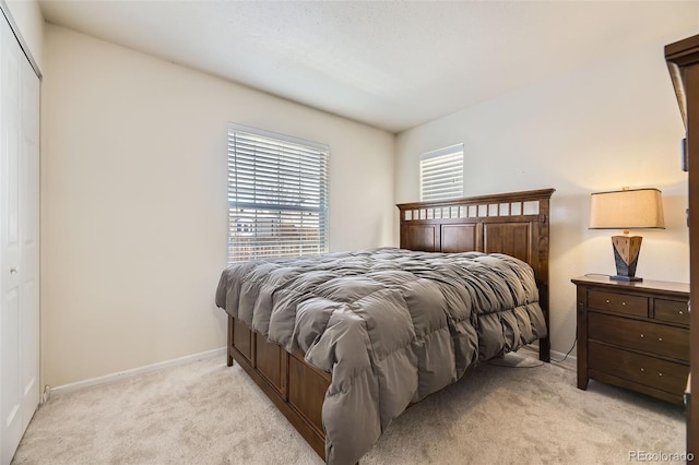 bedroom featuring light carpet