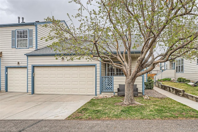 traditional-style house with an attached garage and concrete driveway
