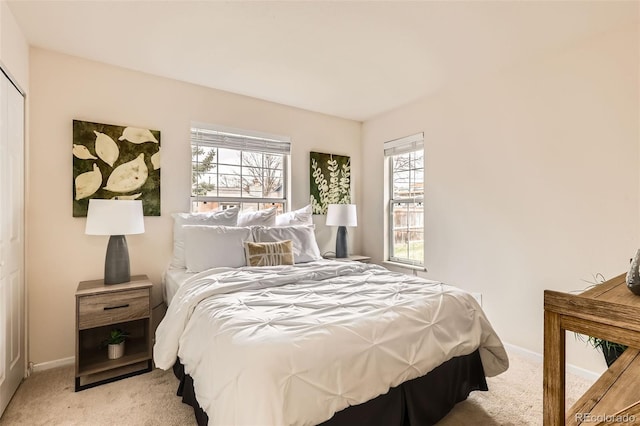 bedroom featuring baseboards and light colored carpet