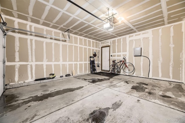 garage featuring a garage door opener and electric panel