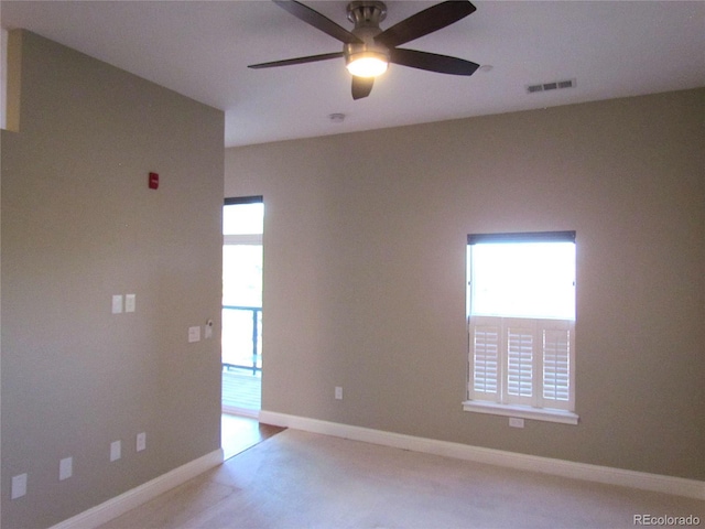 empty room with visible vents, baseboards, and a ceiling fan