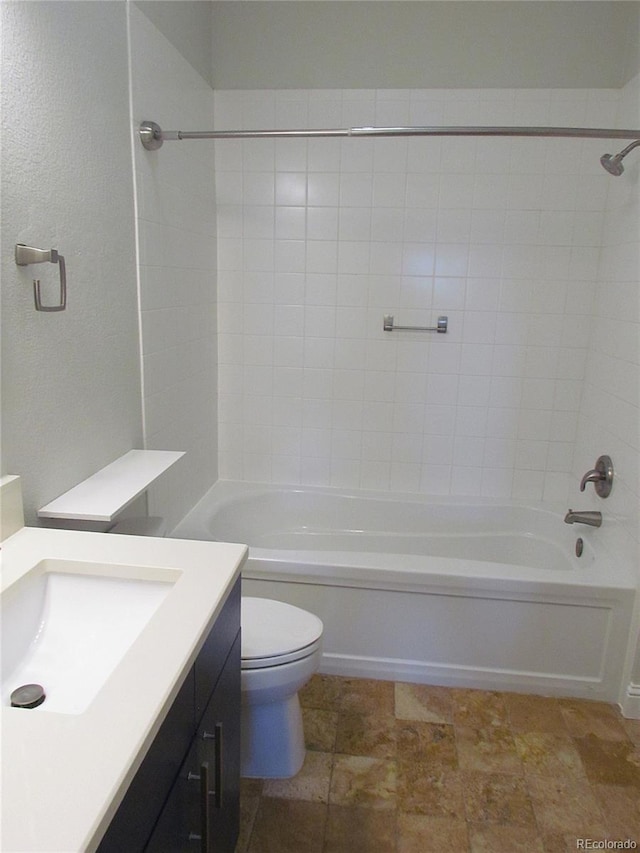 bathroom with tub / shower combination, toilet, and vanity