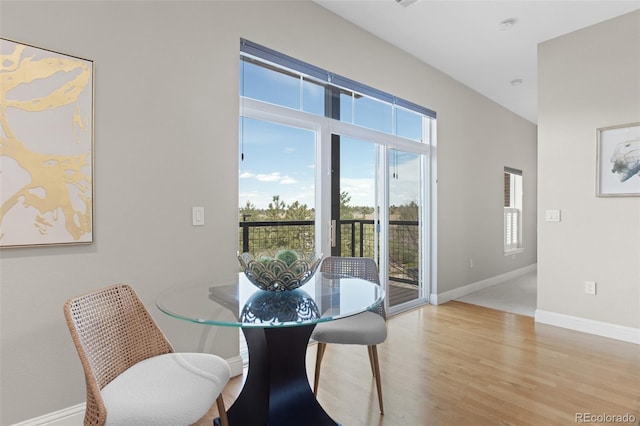 dining space featuring wood finished floors and baseboards