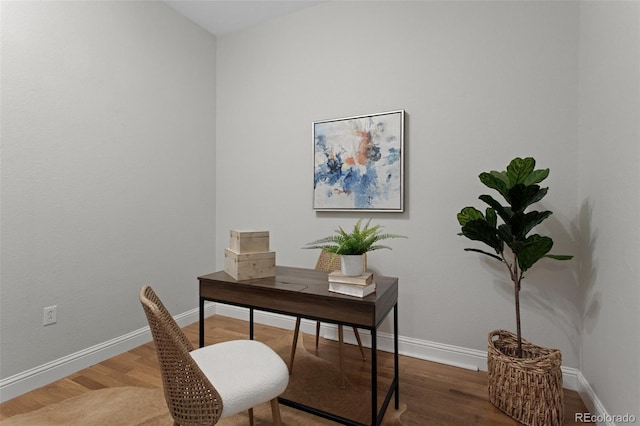 office space with baseboards and wood finished floors