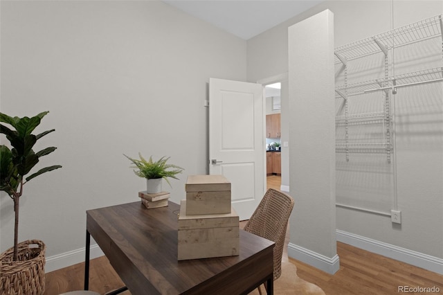 office area featuring light wood-style flooring and baseboards