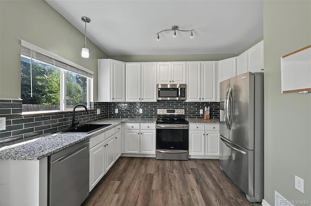 1899 Woodpark Dr, Colorado Springs, CO 80951 - kitchen with appliances with stainless steel finishes, a sink, white cabinetry, and dark wood-style flooring
