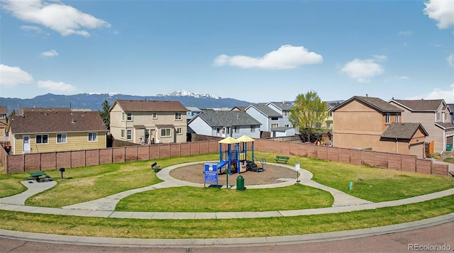 1899 Woodpark Dr, Colorado Springs, CO 80951 - view of home's community featuring a residential view, a playground, and a mountain view