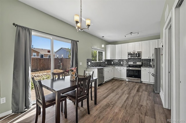 1899 Woodpark Dr, Colorado Springs, CO 80951 - dining area featuring a chandelier and dark wood finished floors