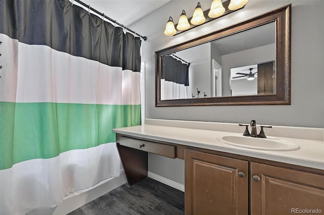 1899 Woodpark Dr, Colorado Springs, CO 80951 - full bath with vanity, ceiling fan, a shower with shower curtain, and wood finished floors