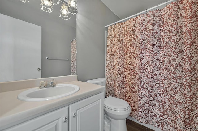 1899 Woodpark Dr, Colorado Springs, CO 80951 - full bathroom featuring toilet, vanity, wood finished floors, and a shower with shower curtain