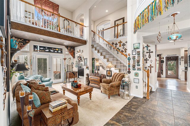 living room featuring a towering ceiling