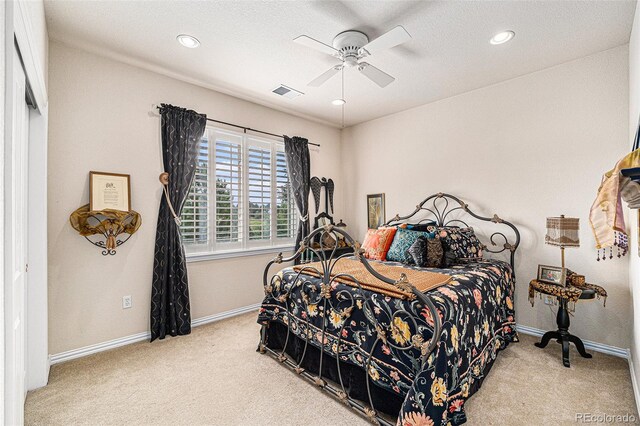 bedroom featuring a textured ceiling, ceiling fan, and carpet floors