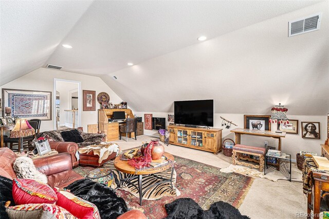 carpeted living room with vaulted ceiling and a textured ceiling