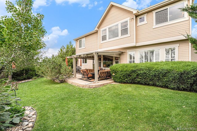 back of house with a patio area and a lawn