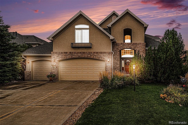 view of front of home with a garage and a yard