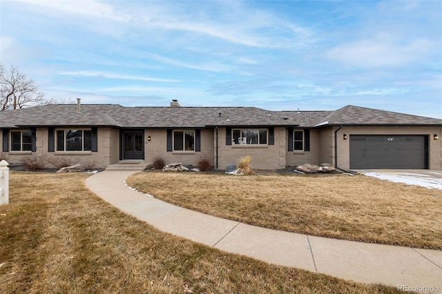 ranch-style house with a garage and a front lawn