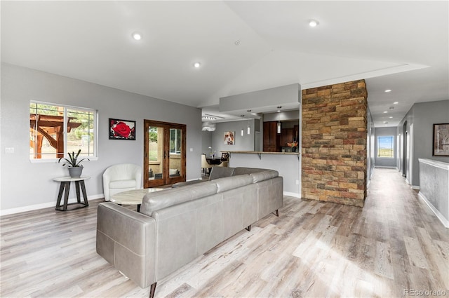 living room with light hardwood / wood-style floors and lofted ceiling