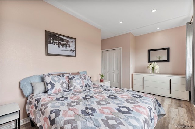 bedroom featuring light wood-type flooring and a closet