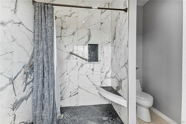 bathroom featuring tile patterned flooring, toilet, and curtained shower