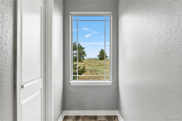 doorway with hardwood / wood-style flooring