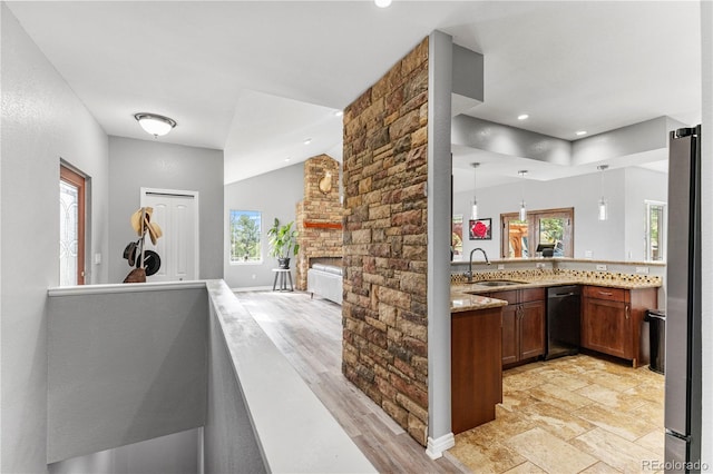 bar with sink, decorative light fixtures, a healthy amount of sunlight, and light hardwood / wood-style flooring