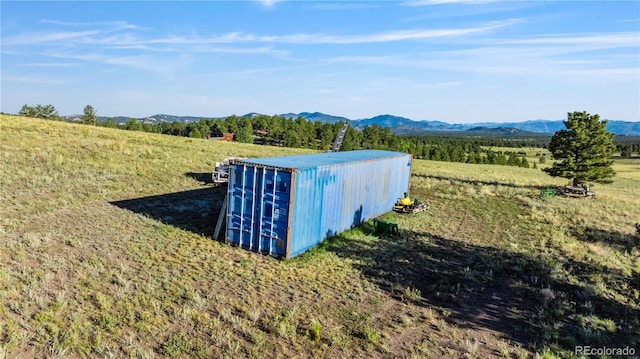 exterior details with a rural view and a mountain view