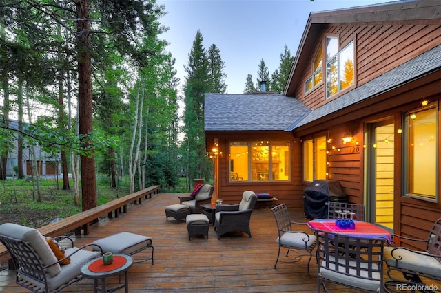 wooden deck with outdoor lounge area and a grill