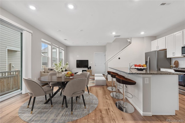 dining room with recessed lighting, visible vents, and light wood finished floors