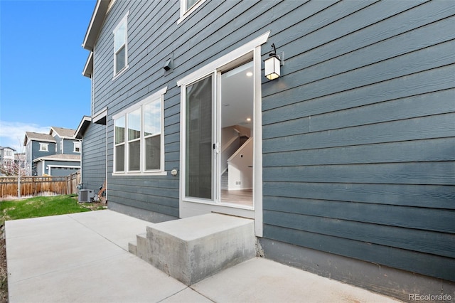exterior space featuring a patio, fence, and central AC unit