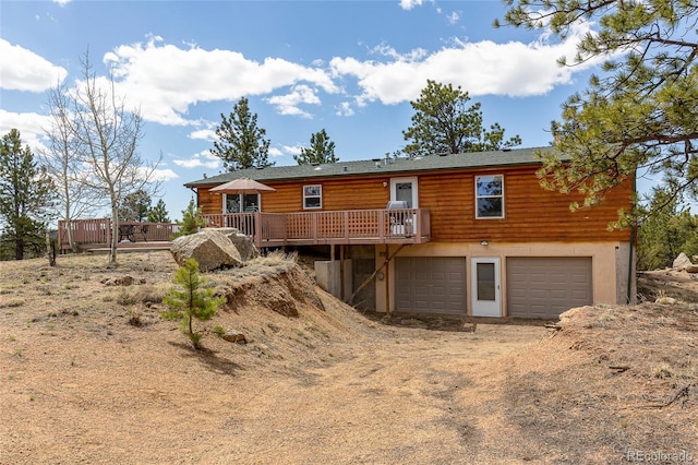 1258 Aspen Trl, Hartsel, CO 80449 - back of house featuring driveway, a garage, a deck, and faux log siding