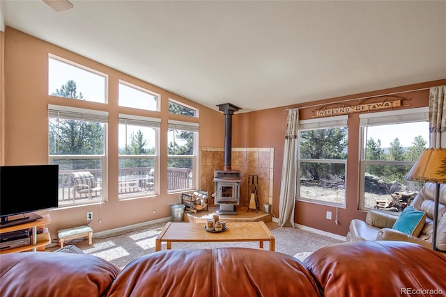 1258 Aspen Trl, Hartsel, CO 80449 - living room with baseboards, a wood stove, lofted ceiling, and carpet floors