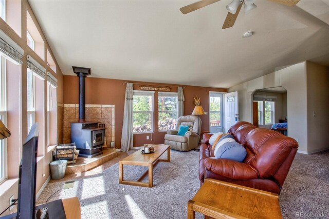 1258 Aspen Trl, Hartsel, CO 80449 - carpeted living room with a ceiling fan, a wood stove, arched walkways, and baseboards