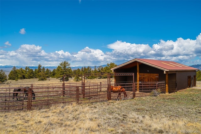 view of horse barn with a rural view and an outdoor structure