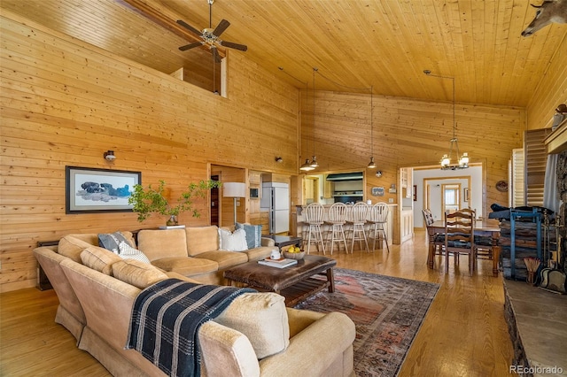 living room with wooden ceiling, hardwood / wood-style floors, a high ceiling, and wood walls