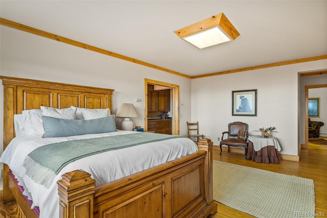 bedroom featuring crown molding and hardwood / wood-style floors