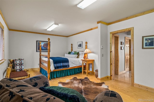 bedroom with ornamental molding and wood-type flooring