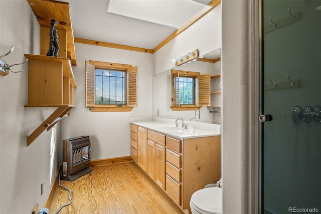 bathroom with ornamental molding, large vanity, toilet, and wood-type flooring