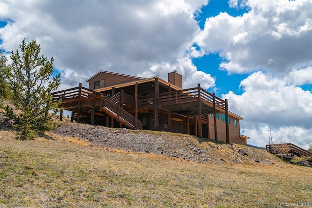 back of house with a deck