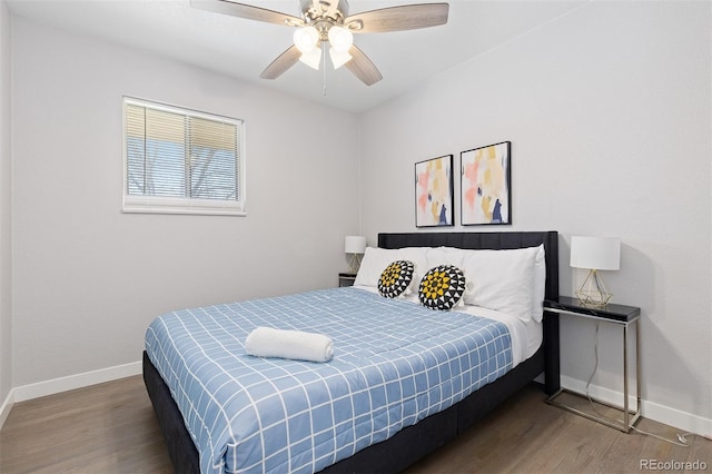 bedroom with baseboards, a ceiling fan, and wood finished floors