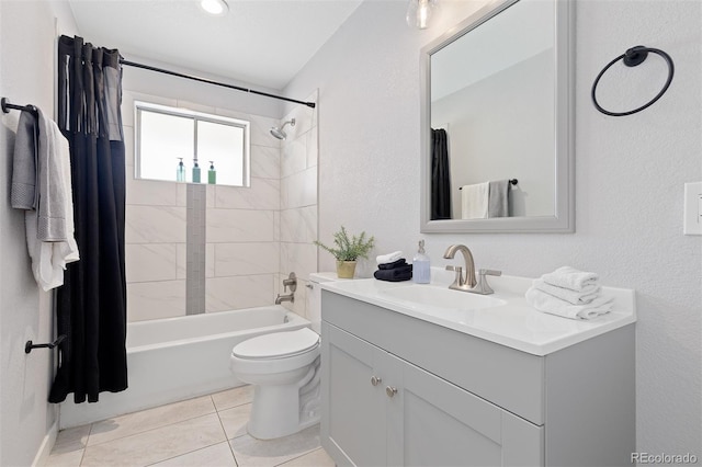 bathroom featuring toilet, shower / tub combo, tile patterned flooring, a textured wall, and vanity