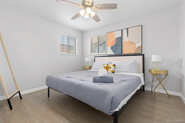 bedroom featuring baseboards, a ceiling fan, and wood finished floors