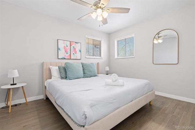 bedroom with wood finished floors, baseboards, and a ceiling fan