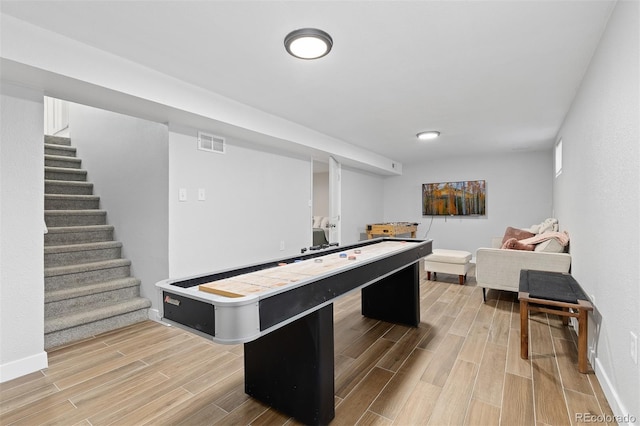 playroom with light wood-type flooring, visible vents, and baseboards