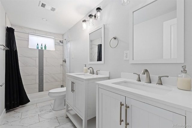 bathroom with marble finish floor, a tile shower, a sink, and visible vents