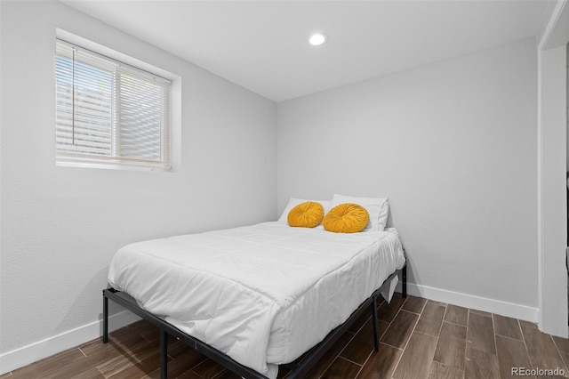 bedroom featuring baseboards, recessed lighting, and dark wood-type flooring