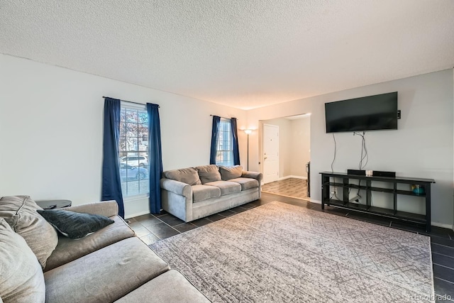 tiled living room featuring a textured ceiling