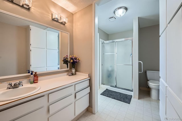 bathroom with a textured ceiling, toilet, walk in shower, and vanity