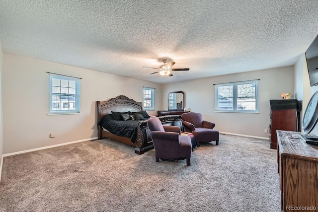 carpeted bedroom with ceiling fan and a textured ceiling